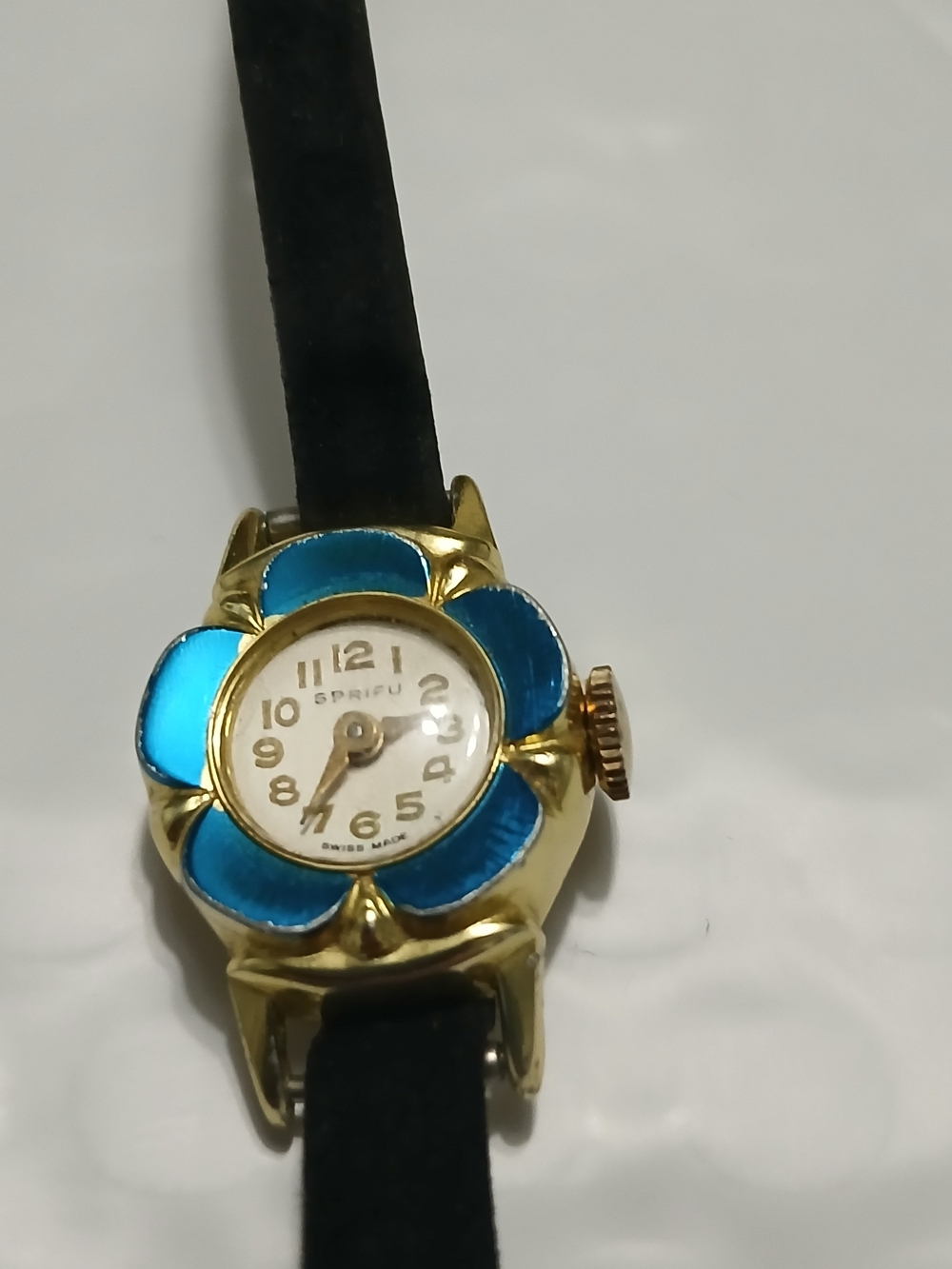 Vintage Gold-Tone Watch with Blue Floral Bezel and Black Strap